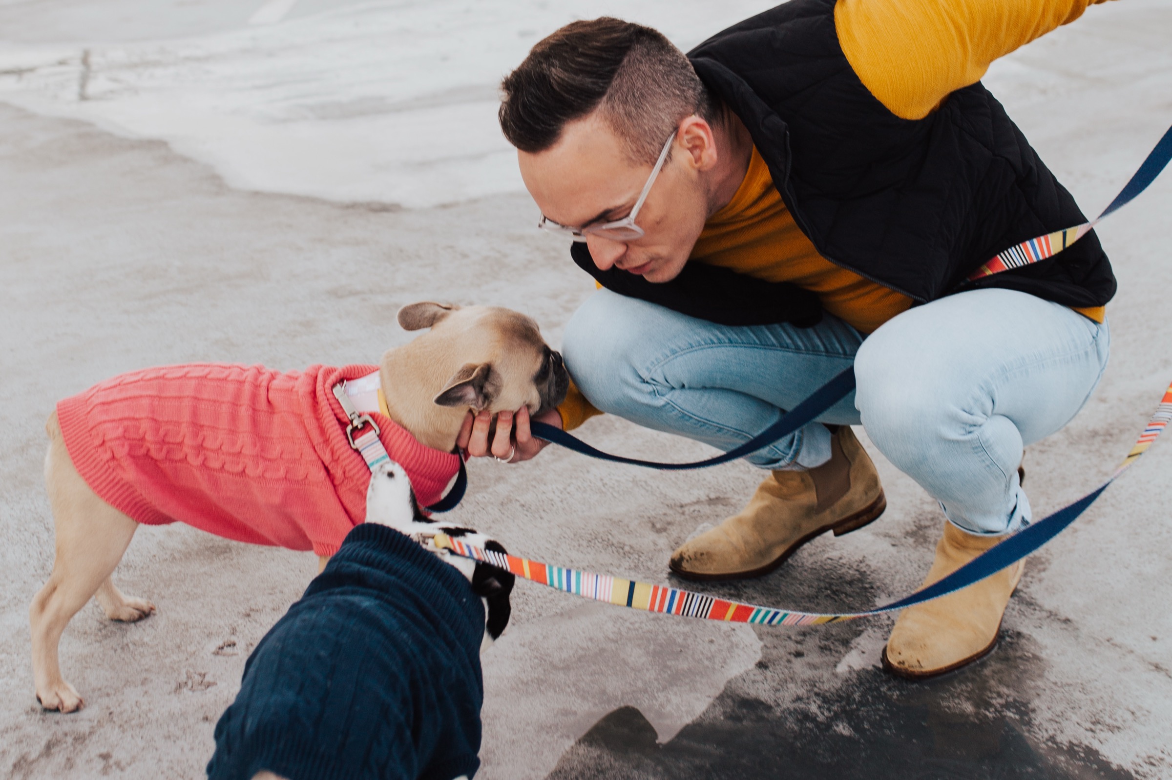 Tyler crouching to greet his dog